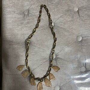 Gold tone necklace with wrapped gold tone wire around pale pink beach glass